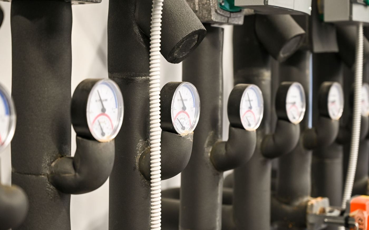 Insulated chilled-water pipes with gauges in the Gharb Jeddah Hospital plant room, an AIM United MEP project